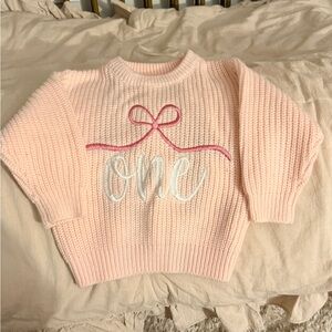 First Birthday Pink Knit Sweater with Bow and 'One' Design
